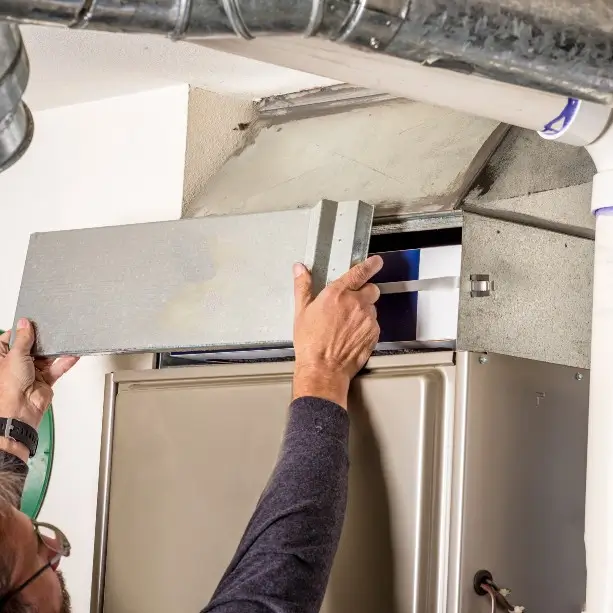 A person replacing a furnace in Fort Collins, Colorado