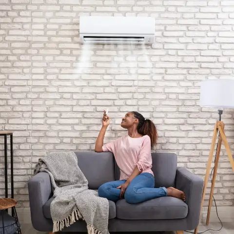 A happy woman in her home after improving her air quality in Northern Colorado